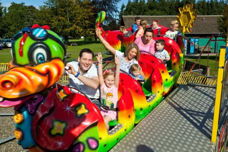 Parents and children enjoy a ride on the Dragon Coaster at Blair Drummond Safari Park